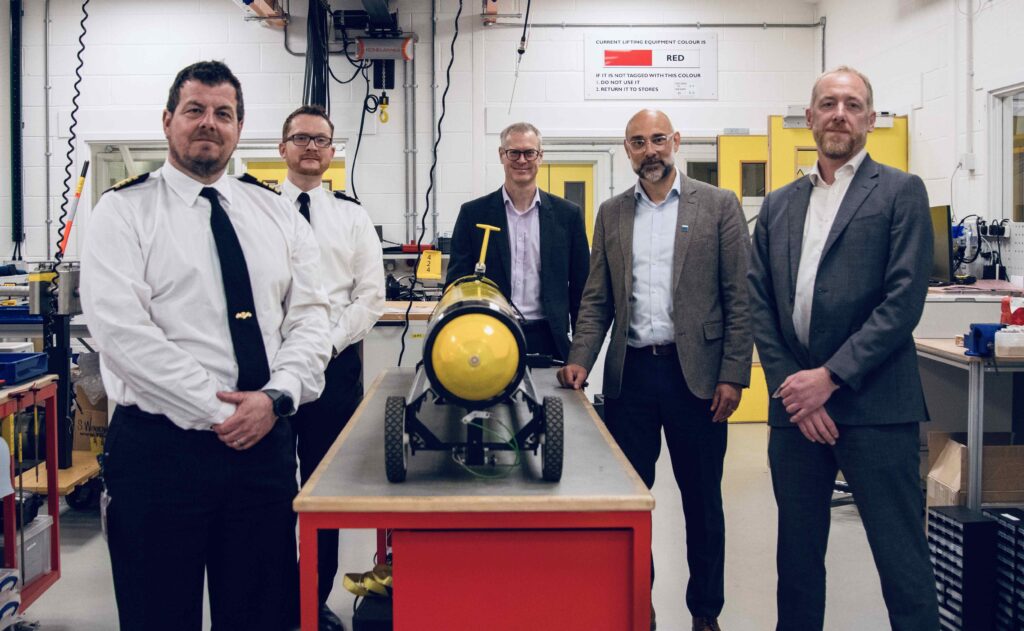 Left to Right: Captain Jim Lovell - Navy Develop - Head of Underwater Battlespace Capability, Commander Mark Butcher - Navy Develop - Hydrographic, Meteorology and Oceanographic Capability Sponsor, Jon Godsell, Maritime Systems Programme Manager, Dstl, NOC CEO Dr John Siddorn, and Andy Liddell, Head of Maritime Unmanned System, SALMO and Boats, Defence Equipment & Support (DE&S)